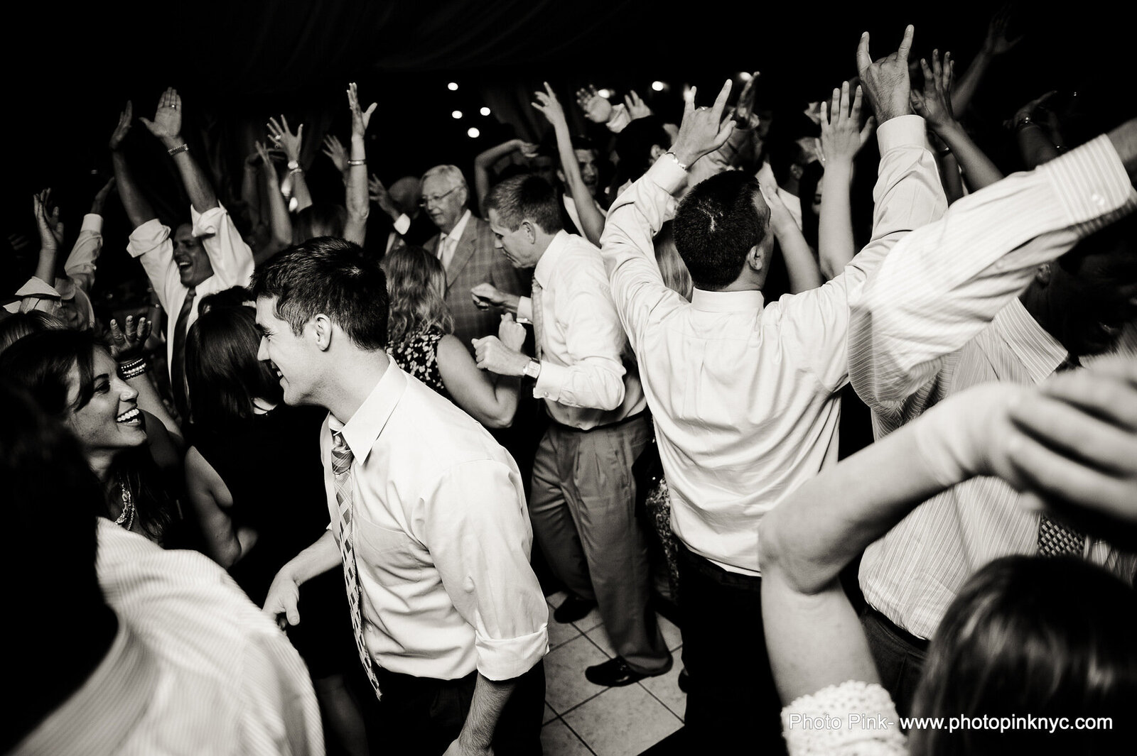 Black and white photograph of a crowded Finger Lakes wedding reception dance floor