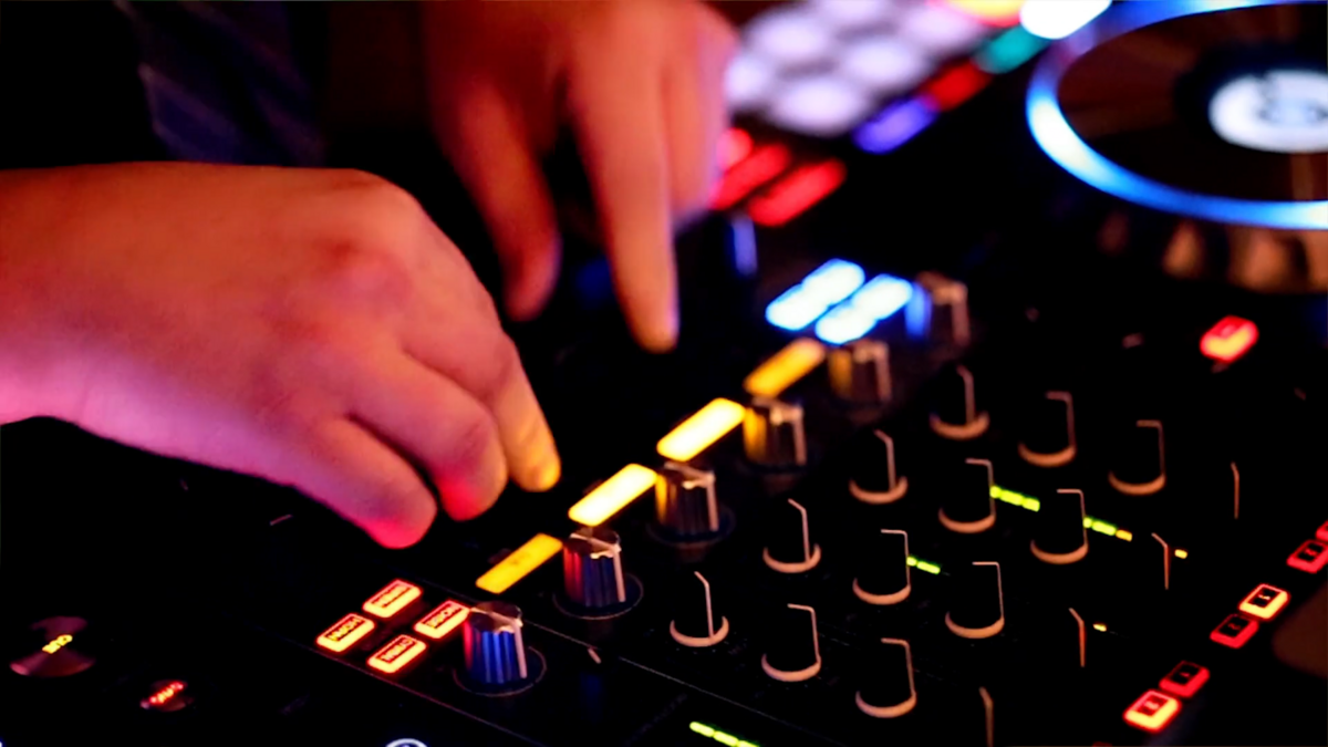 Finger Lakes winery wedding DJ Nathan Baker mixing at a reception